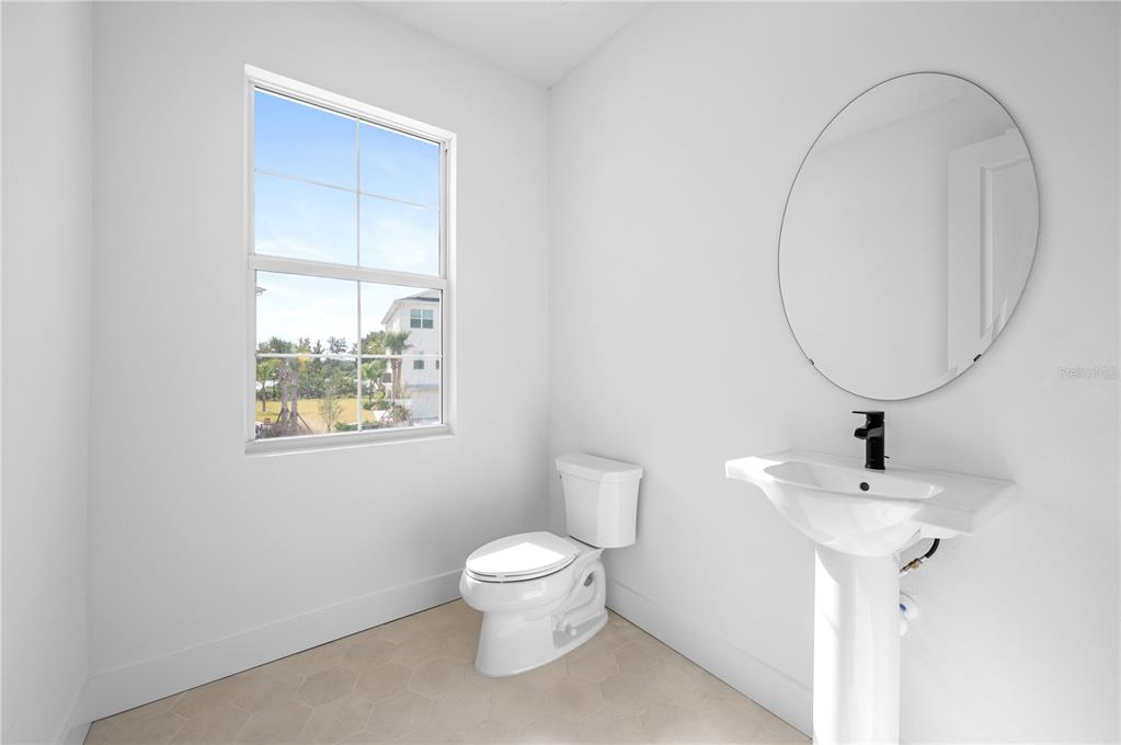 9975 Key Haven Road Seminole, FL 33777 - Photo 22 of 56 a bathroom with a toilet a sink and a mirror