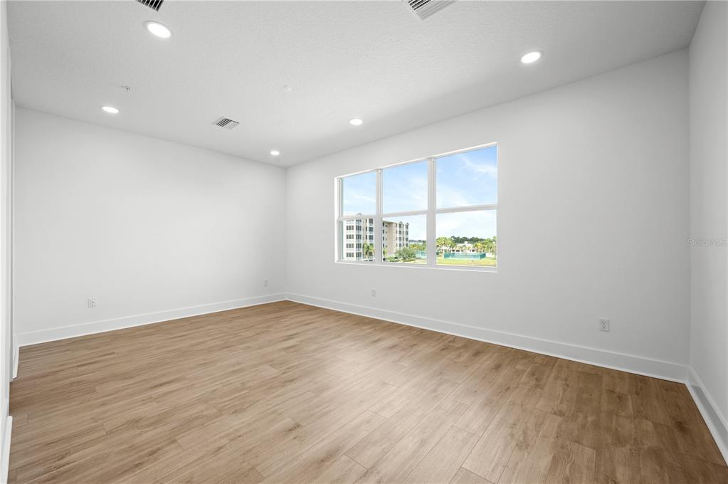 9975 Key Haven Road Seminole, FL 33777 - Photo 24 of 56 an empty room with wooden floor and windows