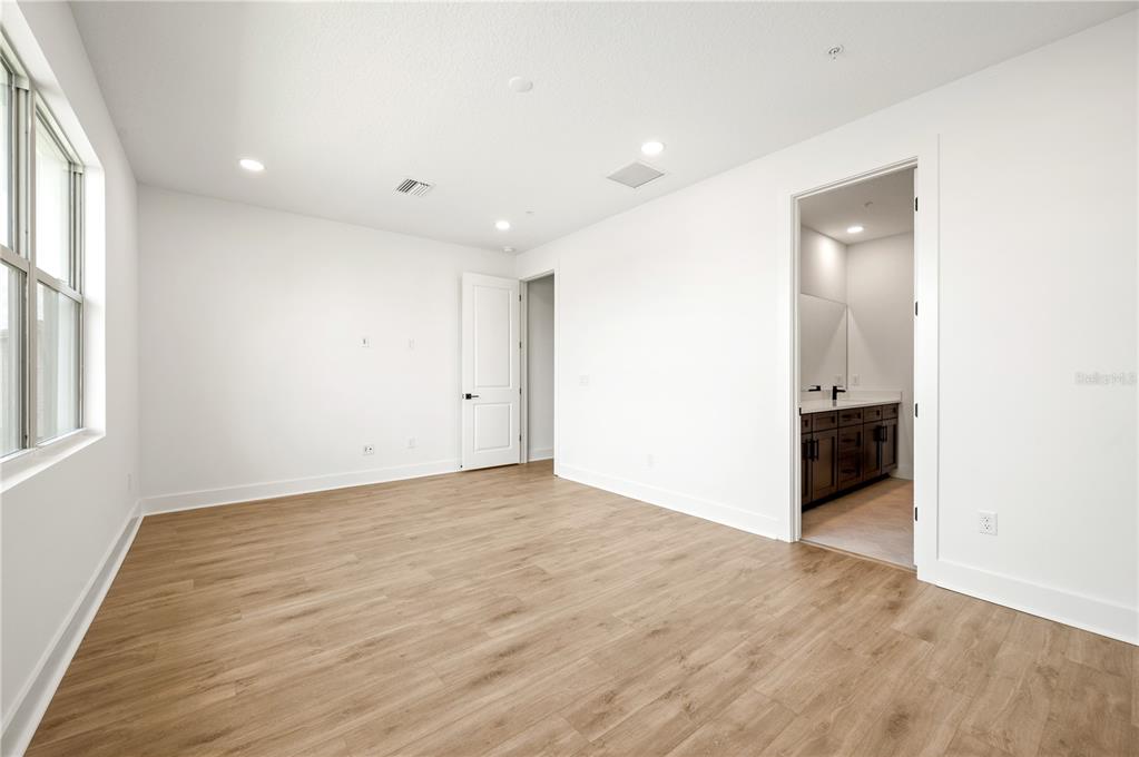 9975 Key Haven Road Seminole, FL 33777 - Photo 25 of 56 an empty room with wooden floor and windows