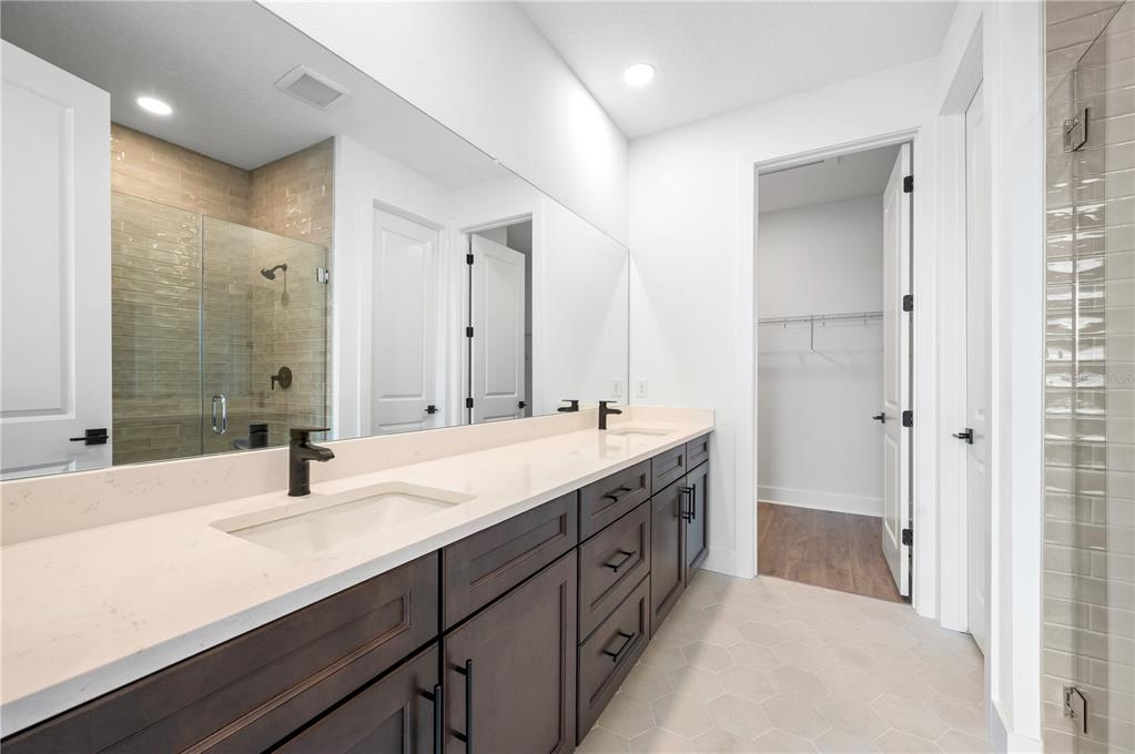 9975 Key Haven Road Seminole, FL 33777 - Photo 27 of 56 a bathroom with double vanity sinks and a mirror