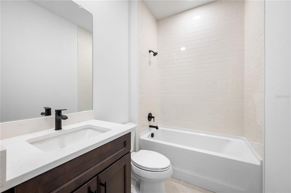 9975 Key Haven Road Seminole, FL 33777 - Photo 31 of 56 a bathroom with a sink a toilet and a bathtub