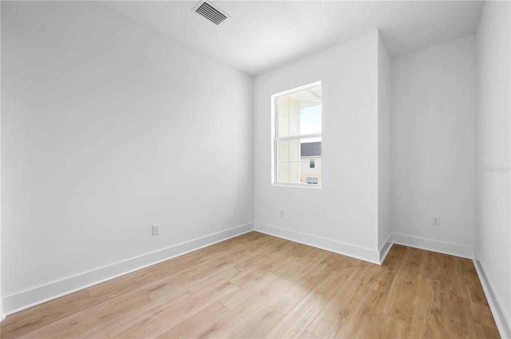 9975 Key Haven Road Seminole, FL 33777 - Photo 34 of 56 an empty room with wooden floor and windows