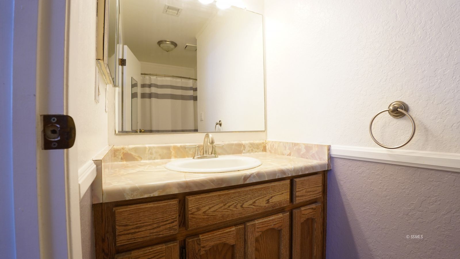 293 East Upjohn Avenue Ridgecrest, CA 93555 - Photo 18 of 21 a bathroom with a granite countertop sink and a mirror