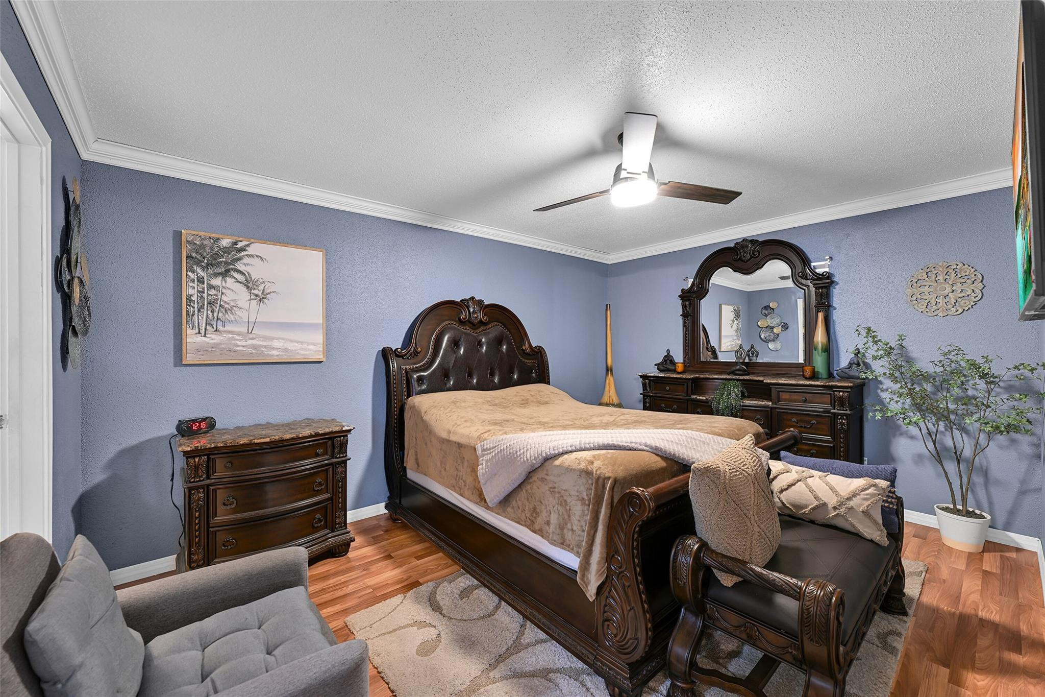 875 Riverside Drive, Unit 732 Coral Springs, FL 33071 - Photo 11 of 16 a bedroom with a bed and wooden floor