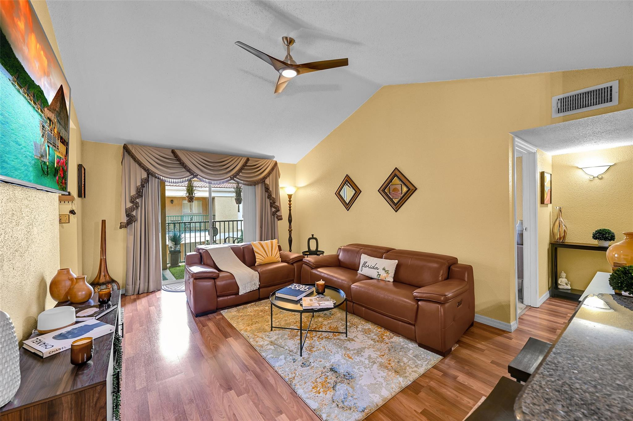 875 Riverside Drive, Unit 732 Coral Springs, FL 33071 - Photo 2 of 16 a living room with furniture and wooden floor