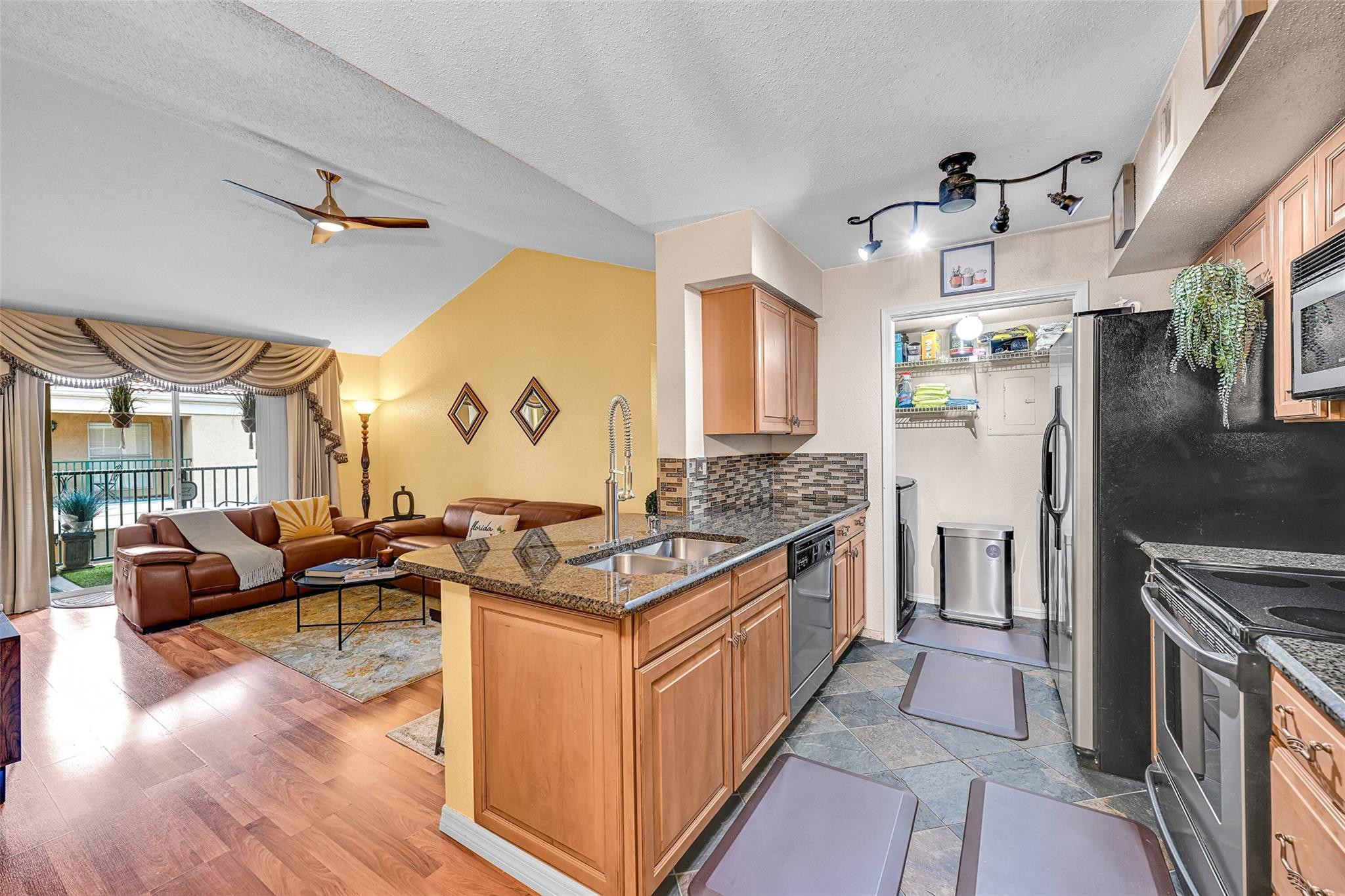 875 Riverside Drive, Unit 732 Coral Springs, FL 33071 - Photo 3 of 16 a kitchen with granite countertop a sink stove and refrigerator