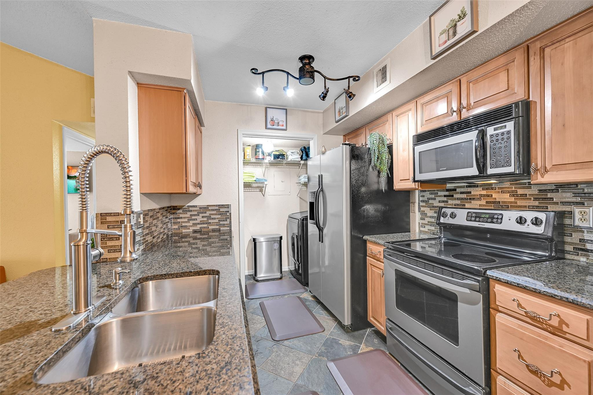 875 Riverside Drive, Unit 732 Coral Springs, FL 33071 - Photo 5 of 16 a kitchen with stainless steel appliances granite countertop a sink stove and refrigerator