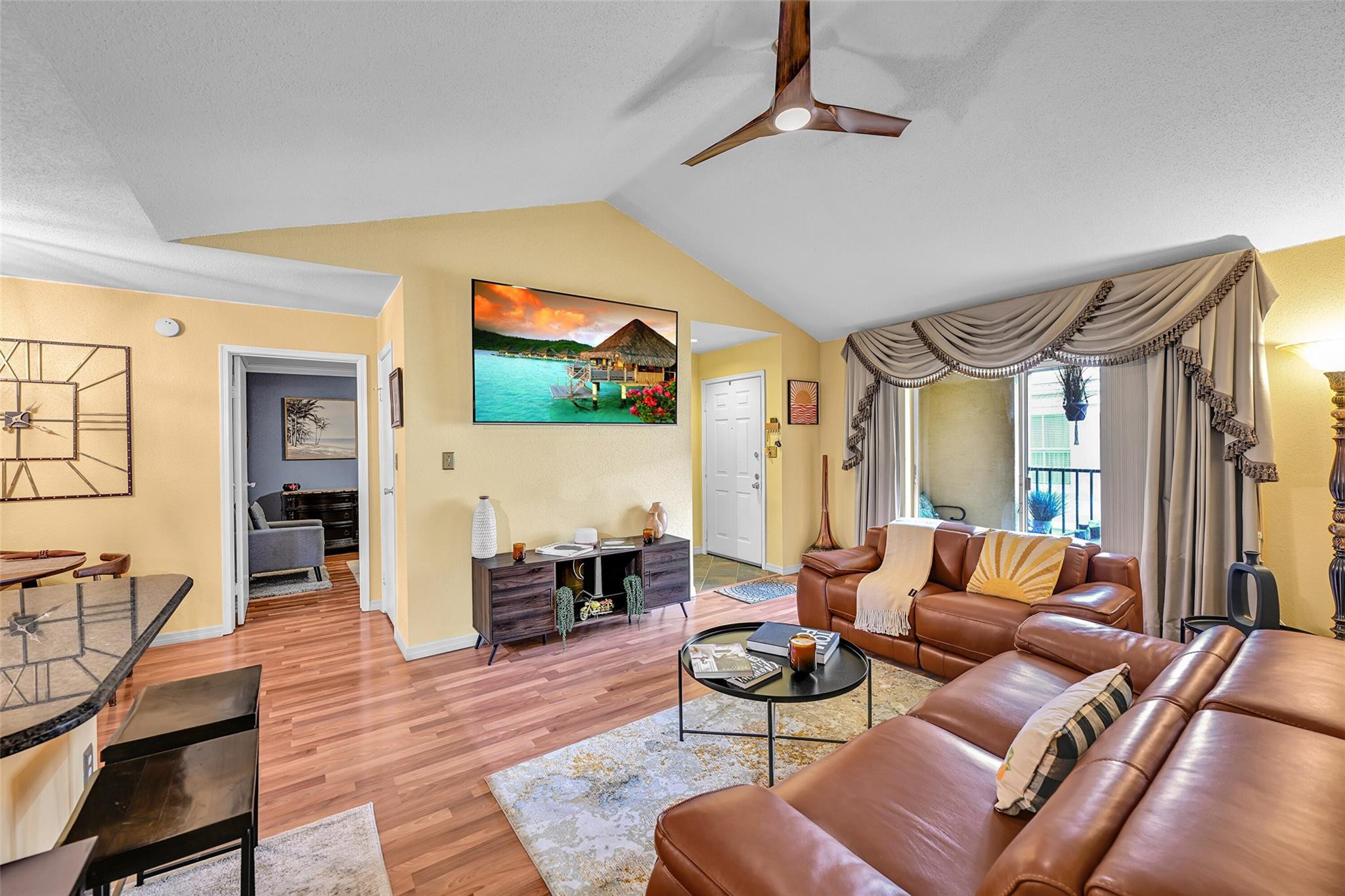 875 Riverside Drive, Unit 732 Coral Springs, FL 33071 - Photo 9 of 16 a living room with furniture and a flat screen tv