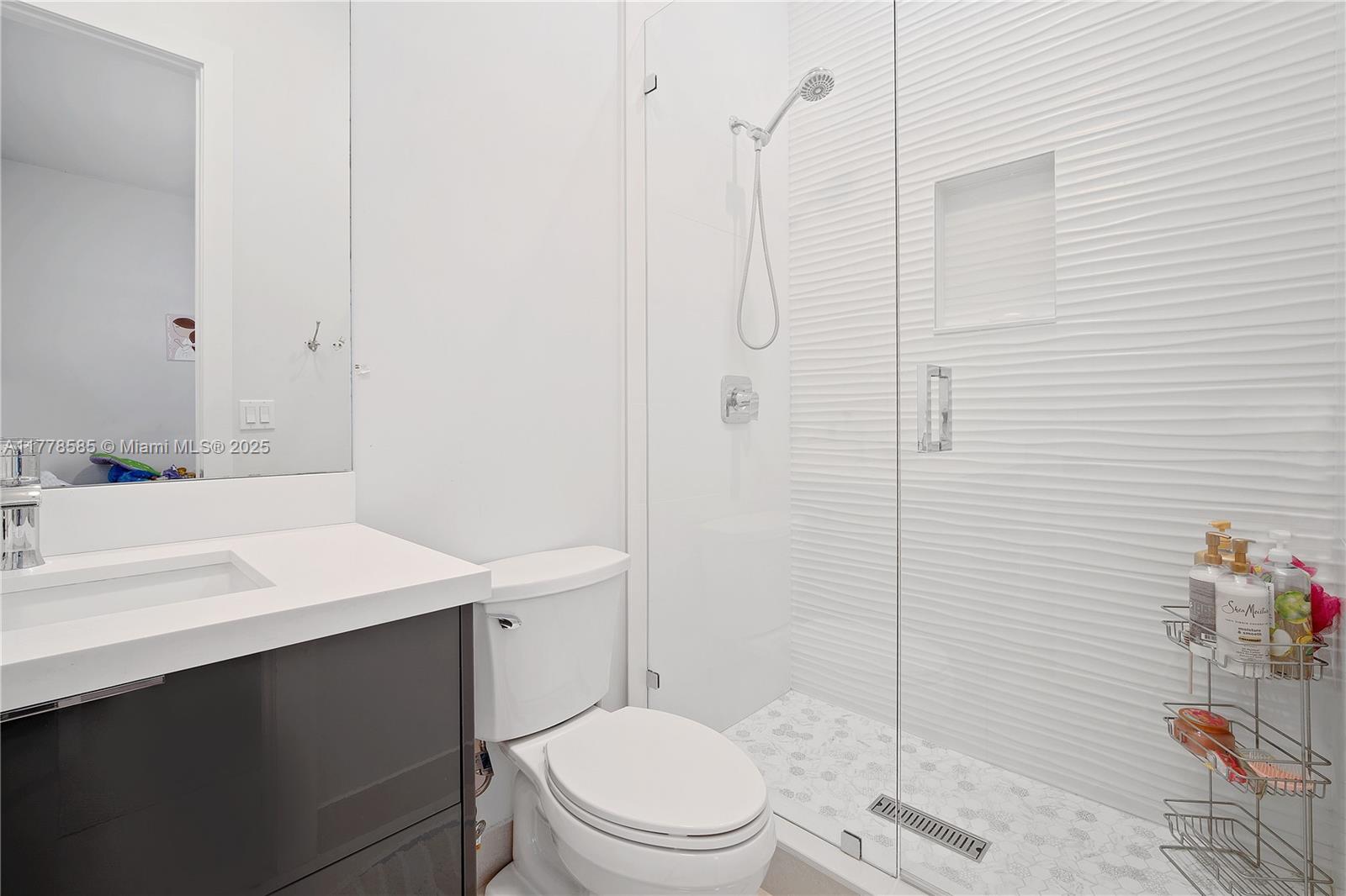 6425 Southwest 27th Street Miami, FL 33155 - Photo 21 of 27 a bathroom with a sink a toilet and shower