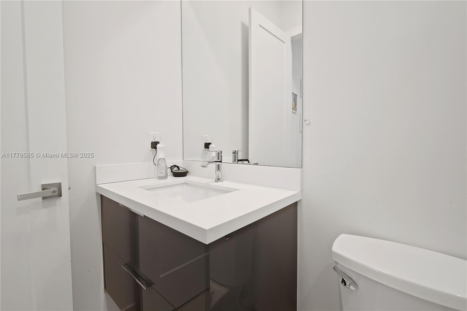 6425 Southwest 27th Street Miami, FL 33155 - Photo 25 of 27 a bathroom with a sink a toilet and a mirror