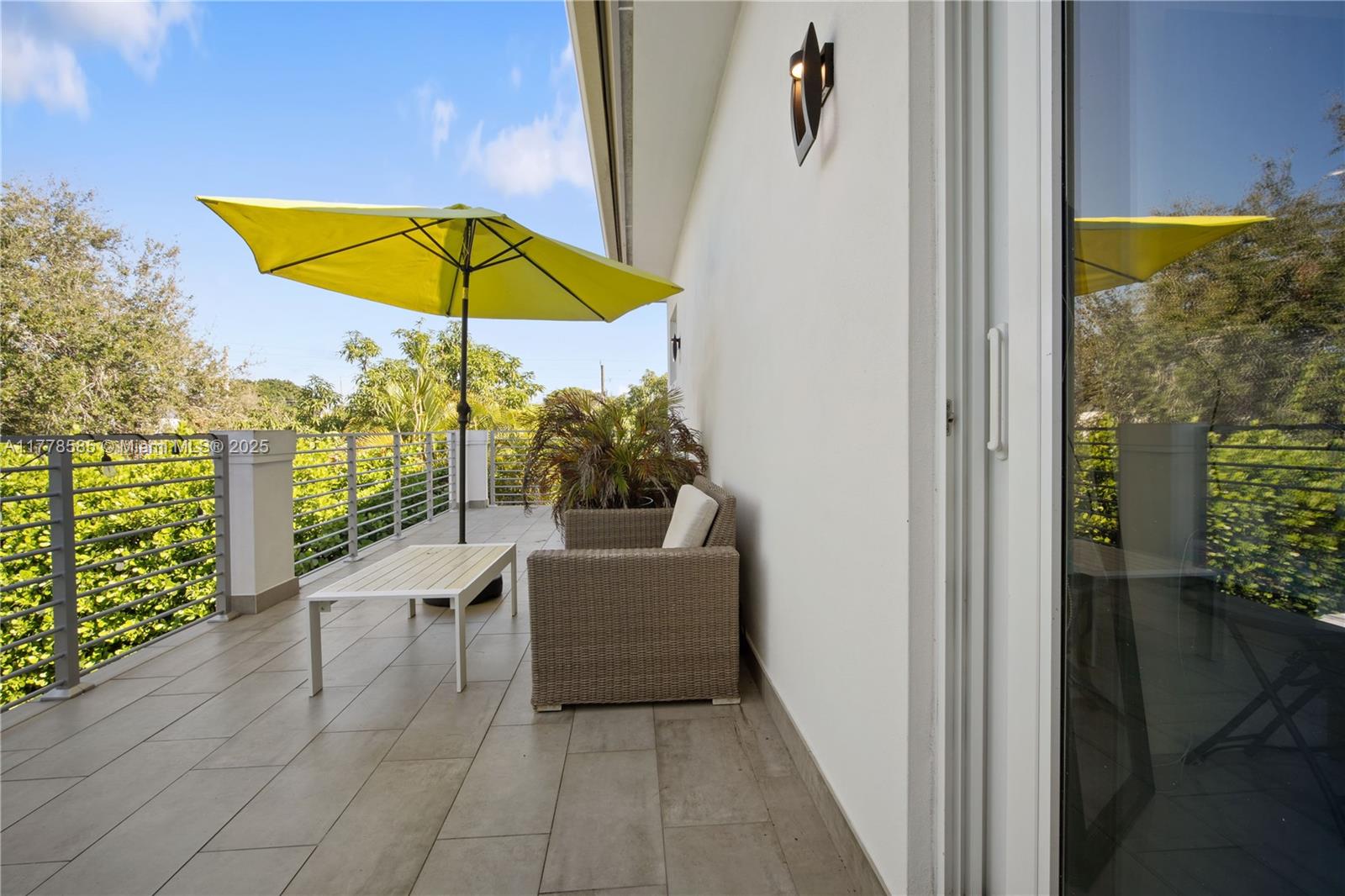 6425 Southwest 27th Street Miami, FL 33155 - Photo 27 of 27 a view of a balcony with chairs and umbrella