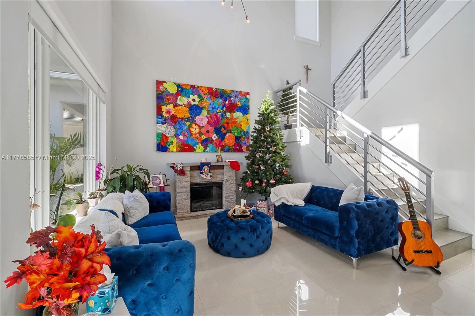 6425 Southwest 27th Street Miami, FL 33155 - Photo 3 of 27 a living room with furniture a flat screen tv and a fireplace