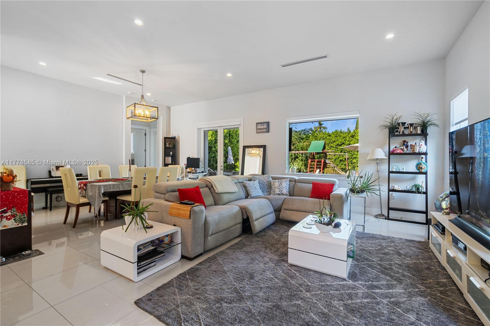 6425 Southwest 27th Street Miami, FL 33155 - Photo 4 of 27 a living room with furniture and a flat screen tv
