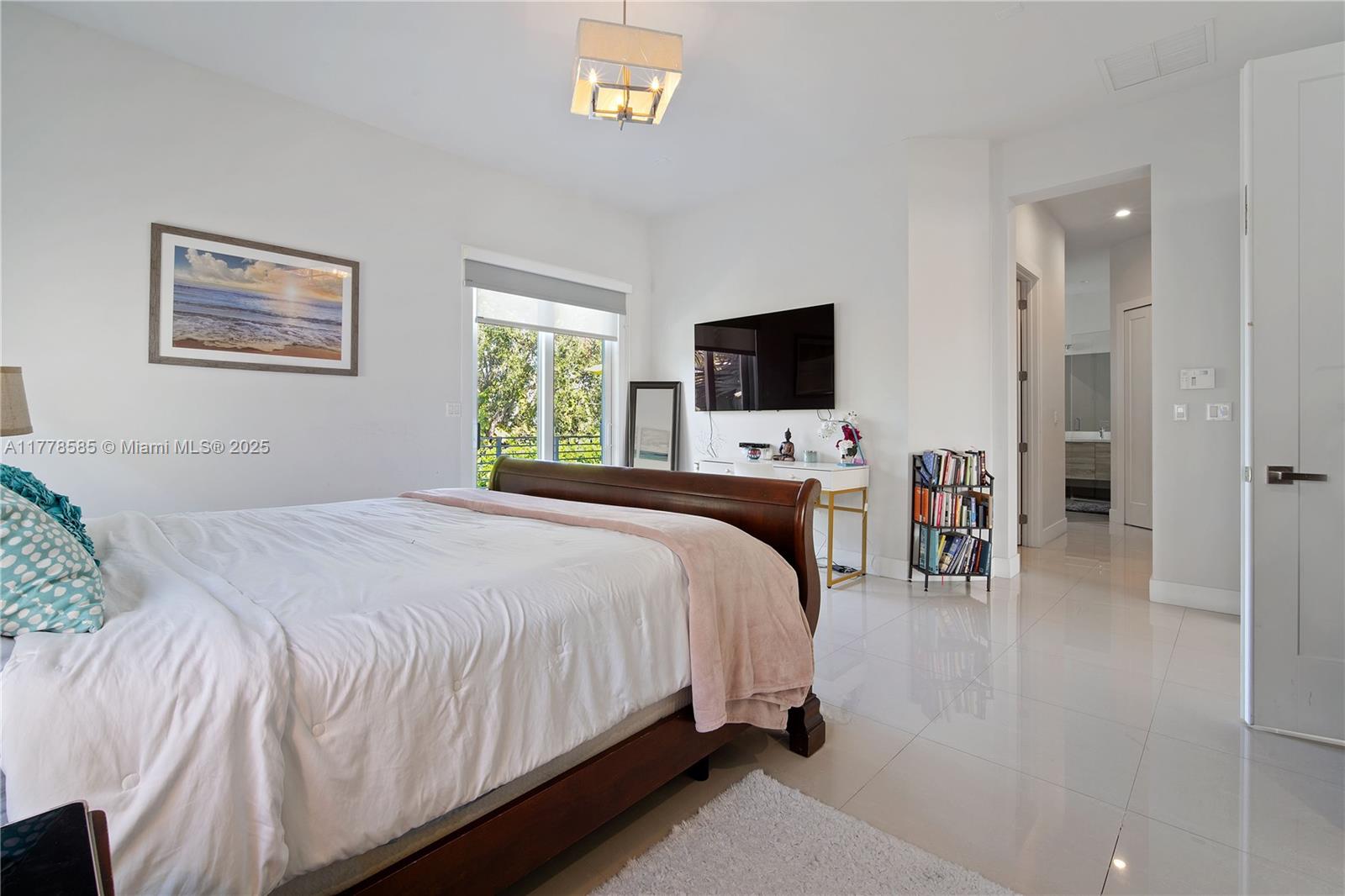 6425 Southwest 27th Street Miami, FL 33155 - Photo 10 of 27 a bedroom with a bed and a flat screen tv
