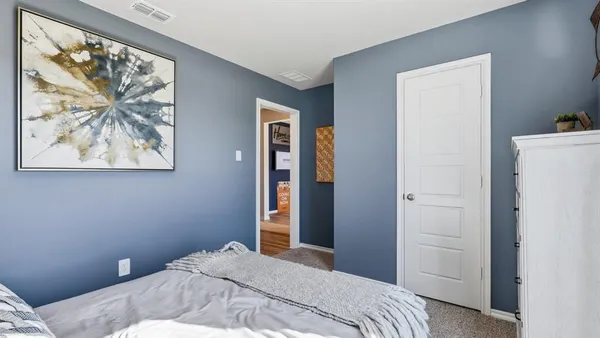 a view of a hallway with a white walls and stairs