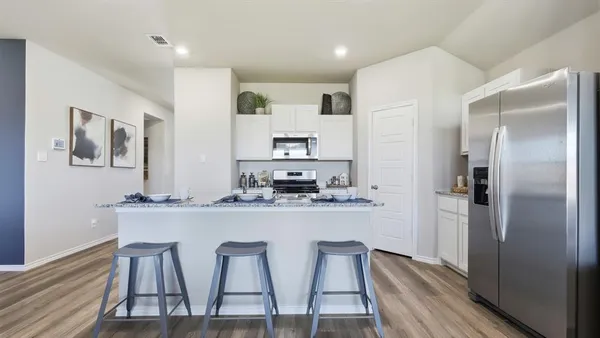 a kitchen with counter space dining table and appliances