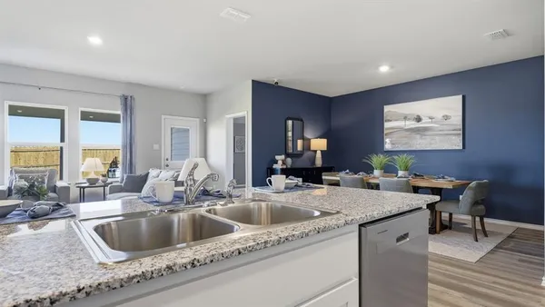 a kitchen with stainless steel appliances a stove a sink refrigerator and microwave