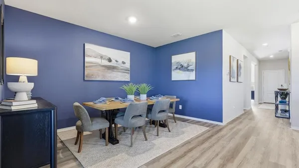a view of kitchen island a sink dining table and chairs