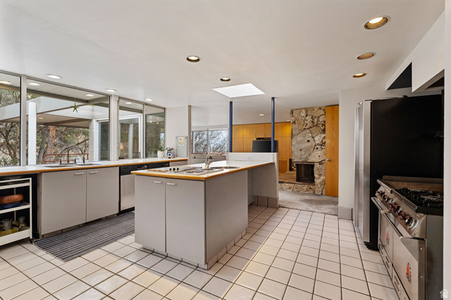 1856 Fort Canyon Road Alpine, UT 84004 - Photo 45 of 49 Spacious kitchen featuring floor-to-ceiling windows, a central island with integrated sink, and white square tile flooring