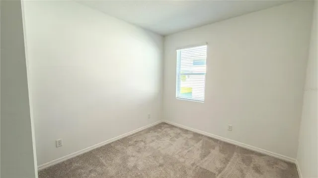 a spacious bathroom with a double vanity sink a mirror and a toilet