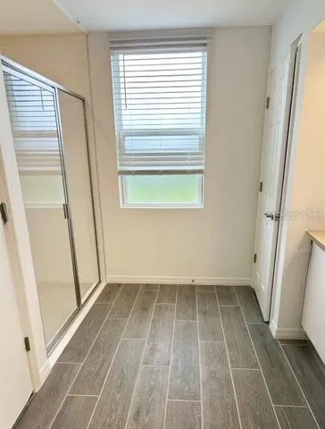 a spacious bathroom with double vanity and a mirror