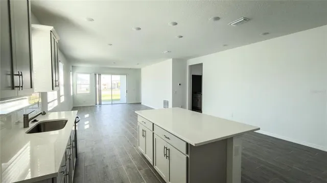 a kitchen with a table chairs and a refrigerator