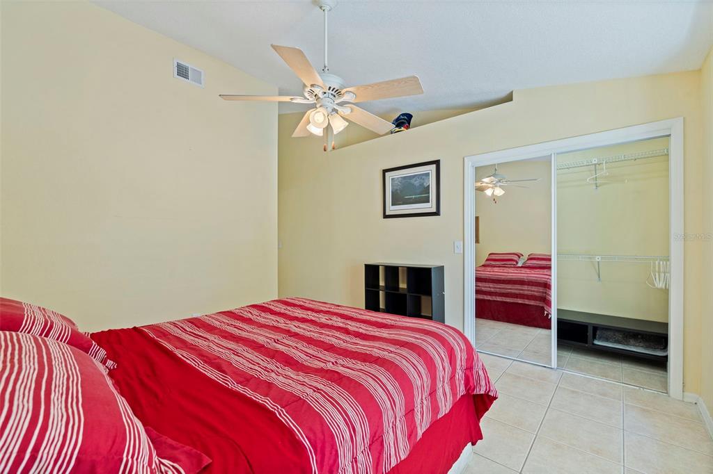 5100 Burchette Road, Unit 2301 Tampa, FL 33647 - Photo 19 of 39 a bedroom with a bed and a chandelier