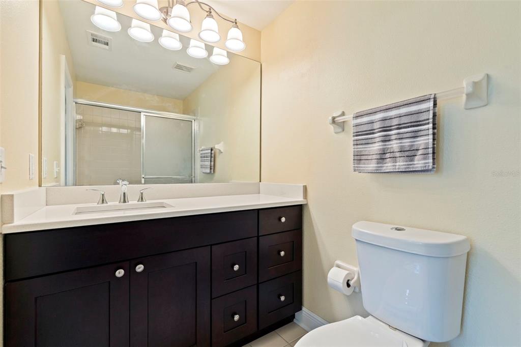 5100 Burchette Road, Unit 2301 Tampa, FL 33647 - Photo 24 of 39 a bathroom with a toilet a sink and mirror