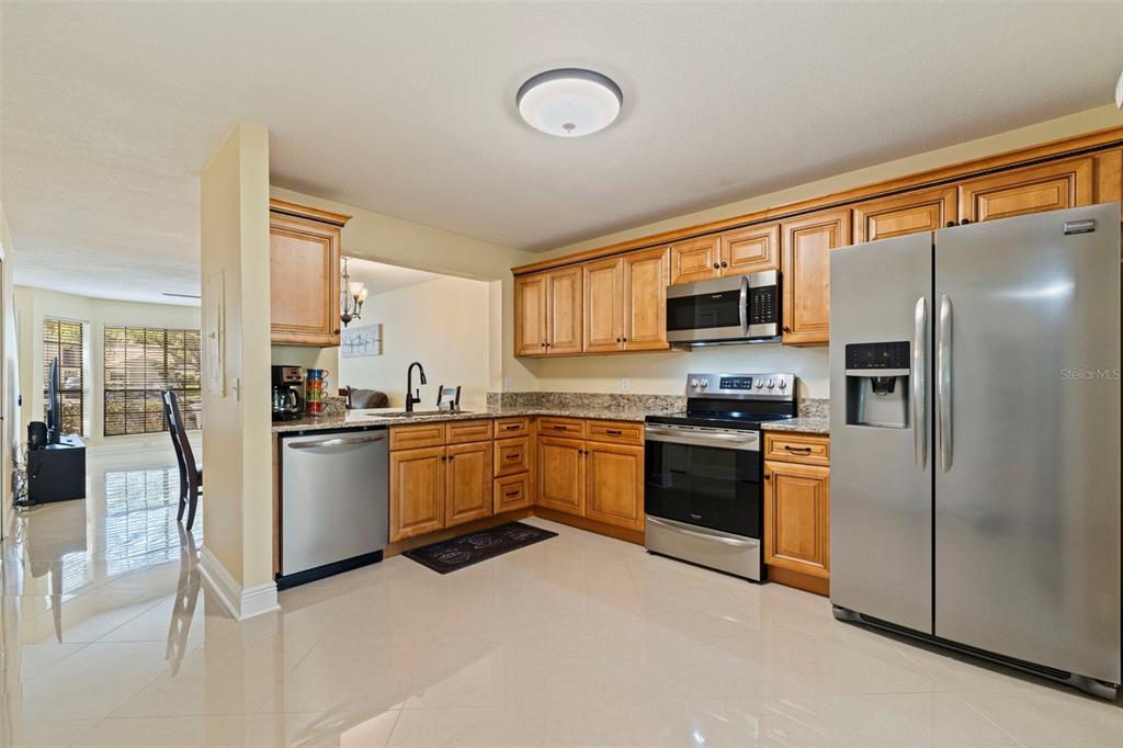 5100 Burchette Road, Unit 2301 Tampa, FL 33647 - Photo 4 of 39 a kitchen with stainless steel appliances granite countertop a refrigerator a stove top oven a sink and dishwasher