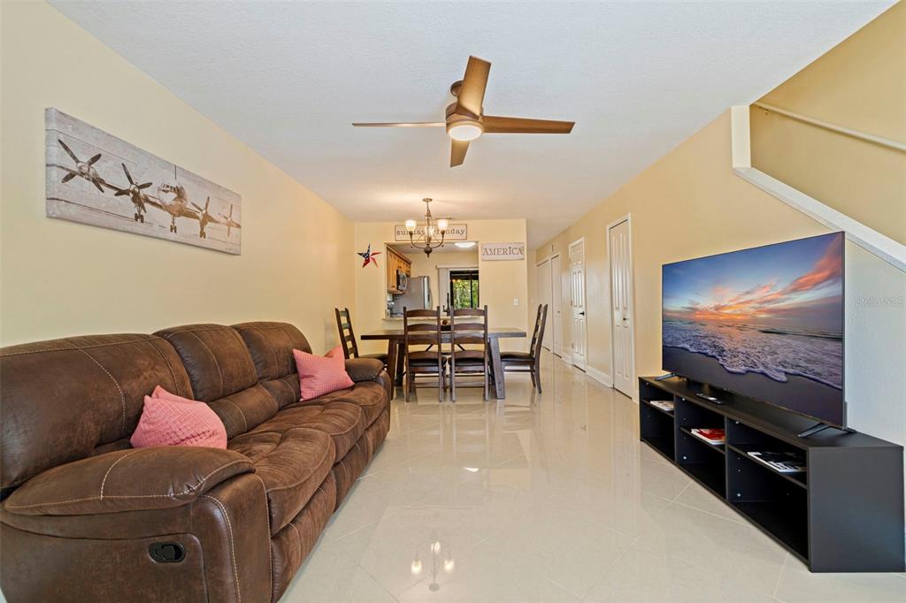 5100 Burchette Road, Unit 2301 Tampa, FL 33647 - Photo 5 of 39 a living room with furniture and a flat screen tv