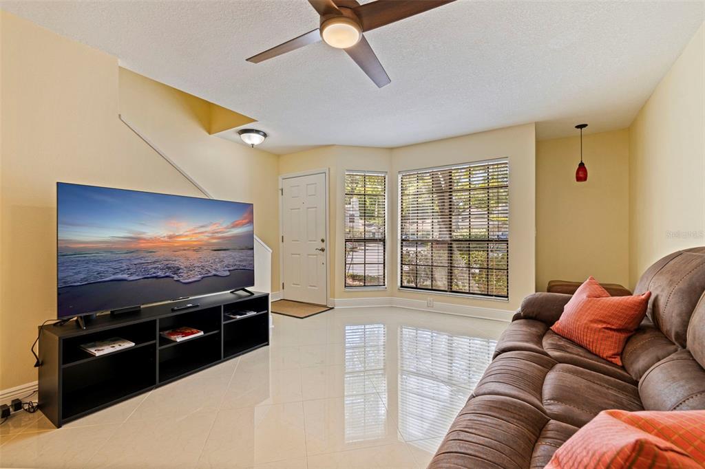 5100 Burchette Road, Unit 2301 Tampa, FL 33647 - Photo 8 of 39 a living room with furniture and a flat screen tv
