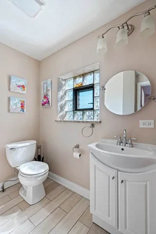 a bathroom with a sink toilet and mirror