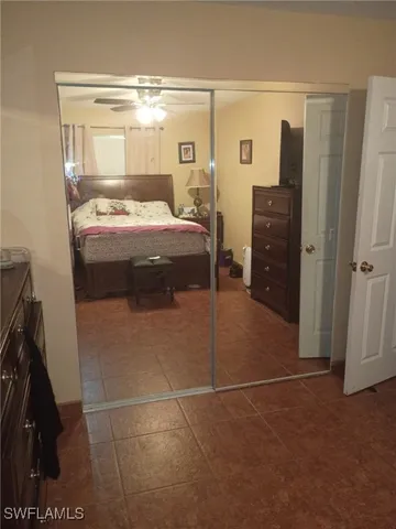 a bedroom with a bed and a mirror