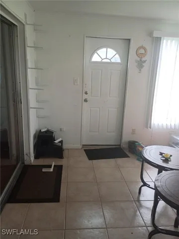 a view of a hallway with furniture and a mirror
