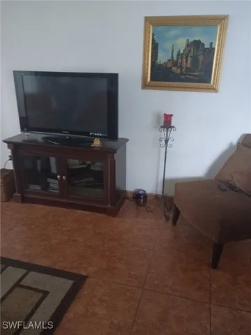 a living room with a flat screen tv and outdoor space