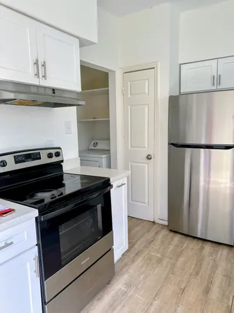 a kitchen with a stove and a refrigerator