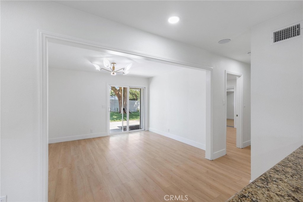 10597 Pendleton Street Riverside, CA 92505 - Photo 14 of 40 a view of an empty room with wooden floor and a window