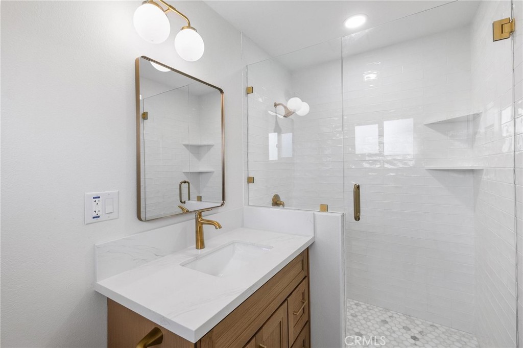 10597 Pendleton Street Riverside, CA 92505 - Photo 22 of 40 a bathroom with a sink a mirror and shower