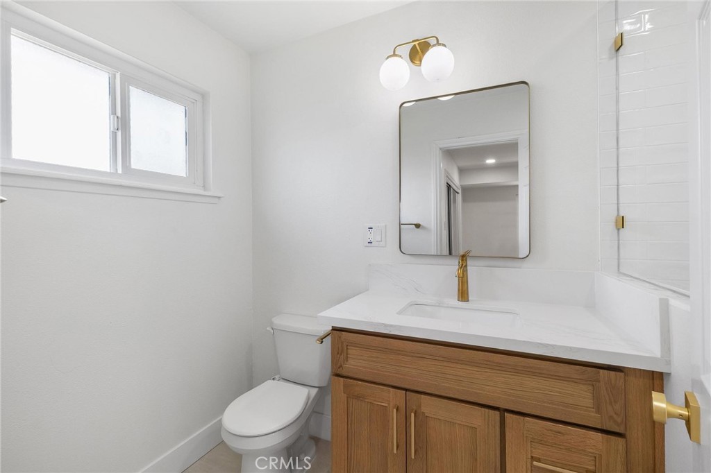 10597 Pendleton Street Riverside, CA 92505 - Photo 23 of 40 a bathroom with a toilet sink and mirror