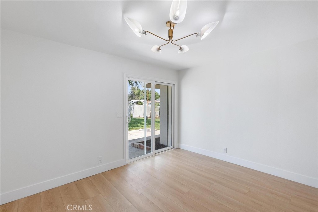 10597 Pendleton Street Riverside, CA 92505 - Photo 24 of 40 an empty room with wooden floor fan and windows