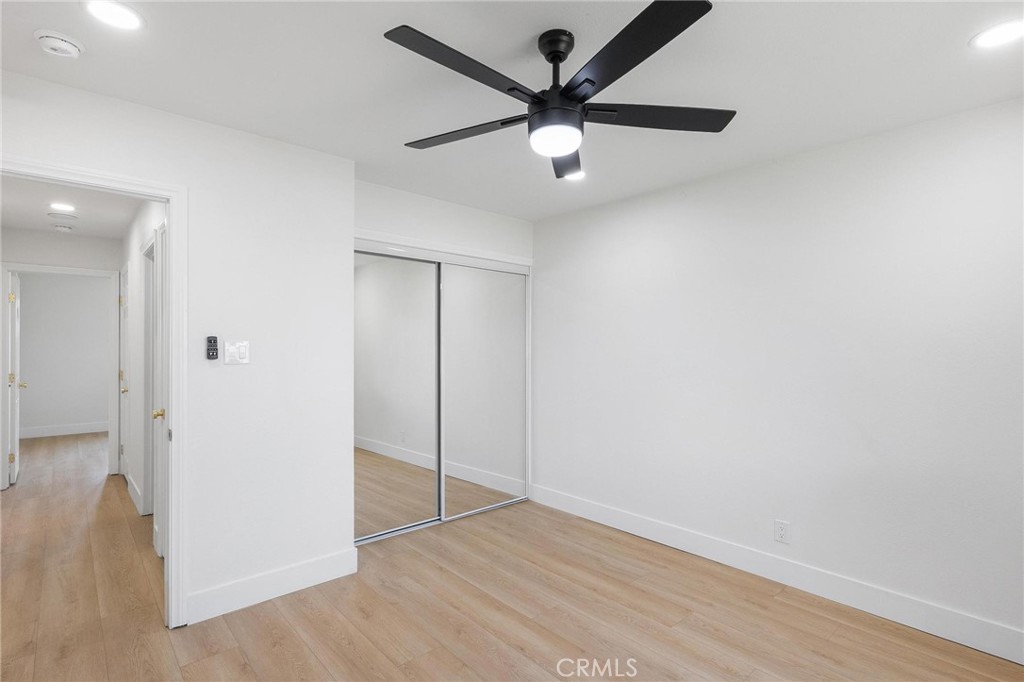 10597 Pendleton Street Riverside, CA 92505 - Photo 30 of 40 an empty room with wooden floor and a ceiling fan