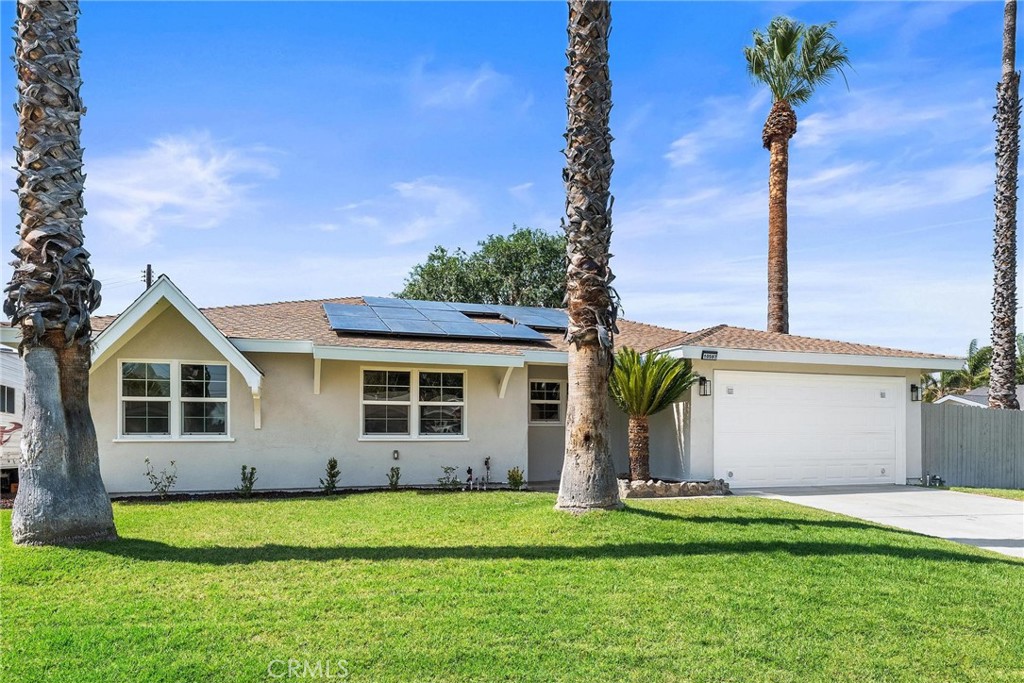 10597 Pendleton Street Riverside, CA 92505 - Photo 4 of 40 a front view of a house with a garden and yard