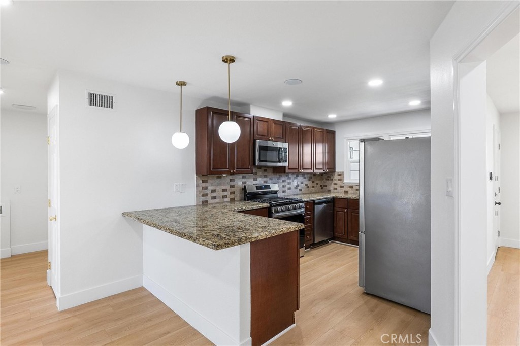 10597 Pendleton Street Riverside, CA 92505 - Photo 8 of 40 a kitchen with a refrigerator a sink and a stove