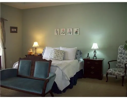 a living room with furniture and a lamp