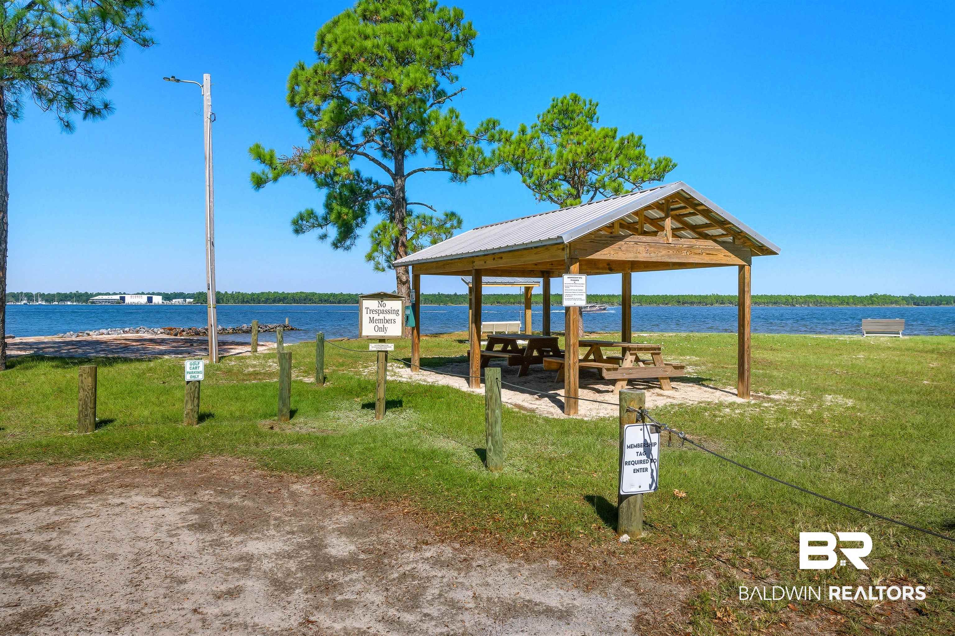 5310 Pine Road Orange Beach, AL 36561 - Photo 9 of 46 View of community featuring a water view, a lawn, and a patio area
