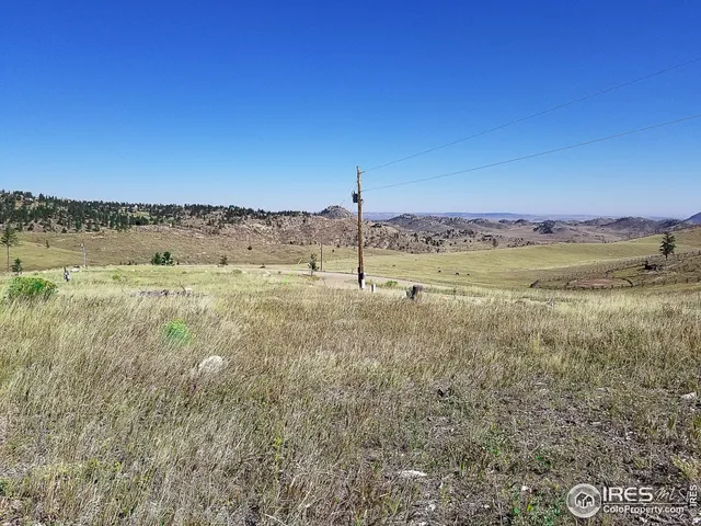 a view of a field with an ocean