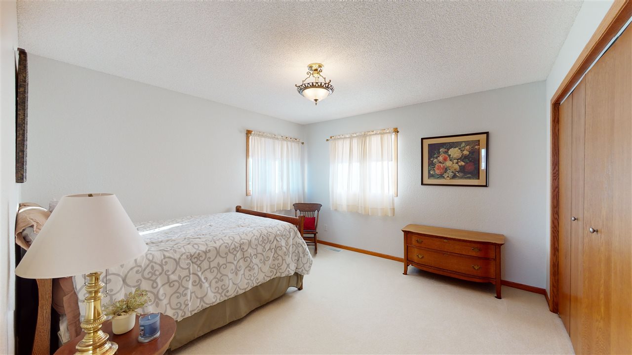 3028 South Golf Road Stockton, IL 61085 - Photo 15 of 26 a bedroom with a bed dresser and window