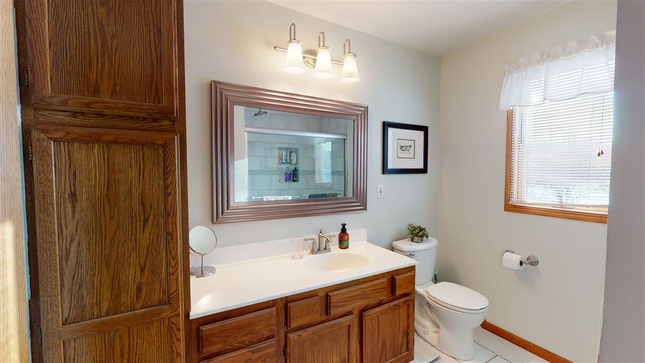 3028 South Golf Road Stockton, IL 61085 - Photo 16 of 26 a bathroom with a sink a toilet and a mirror