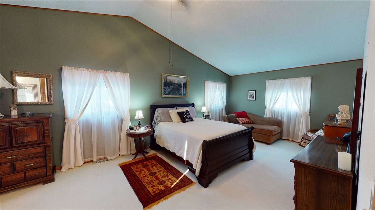 3028 South Golf Road Stockton, IL 61085 - Photo 19 of 26 a bed room with a bed lamp and a dresser