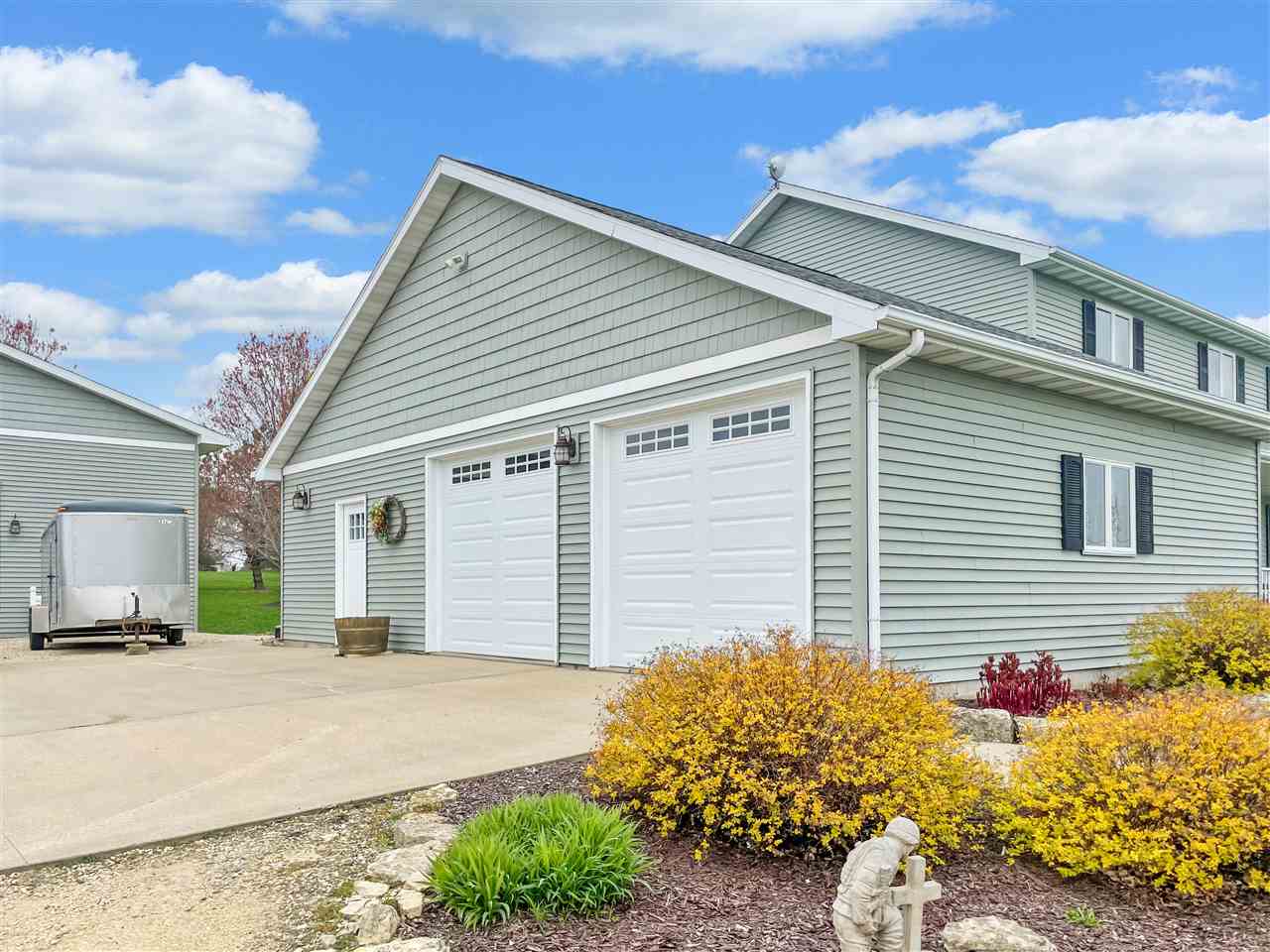 3028 South Golf Road Stockton, IL 61085 - Photo 2 of 26 a front view of a house with a yard and garage